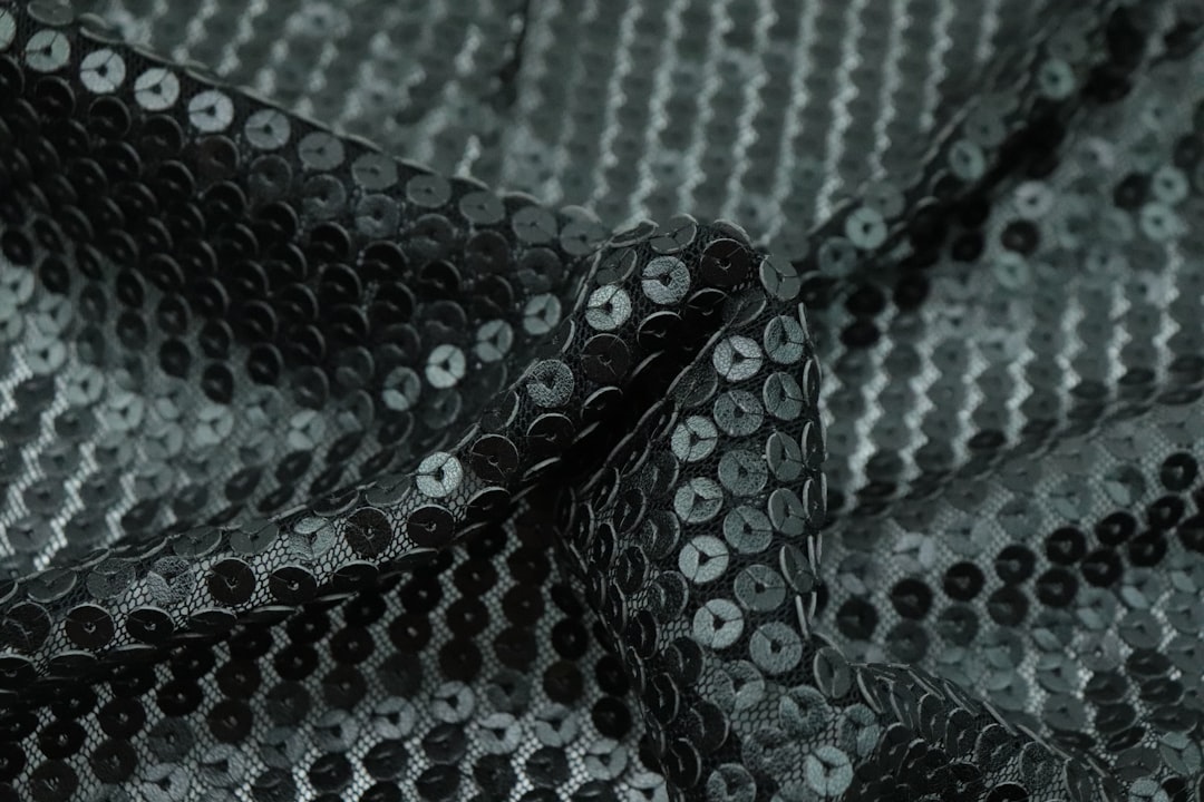 a-close-up-of-a-black-and-silver-sequin-fabric-6tn1jfgmwko
